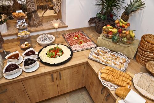 a table filled with lots of different types of food at Alpin Hotel Gudrun in Colle Isarco