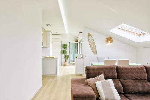 a living room with a couch and a table at Sea & River Vagueira Apartment by Home Sweet Home Aveiro in Praia da Vagueira