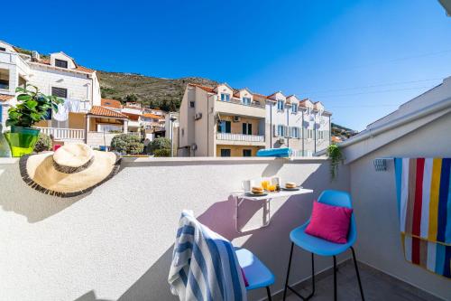 a balcony with a table and chairs on a roof at Jele Rooms in Dubrovnik