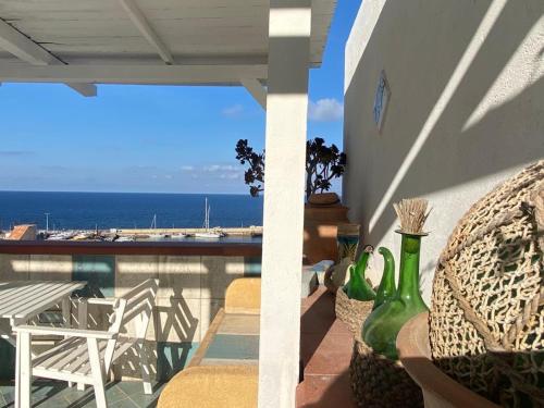 a balcony with chairs and a view of the ocean at Rosa Dei Venti Marettimo in Marettimo