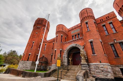 a large red brick building with stairs in front at Amsterdam Castle NY in Amsterdam