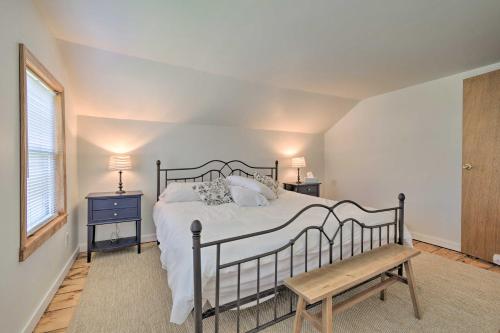 a bedroom with a bed and a bench and a window at Getaway in Sodus Point with Private Yard in Sodus