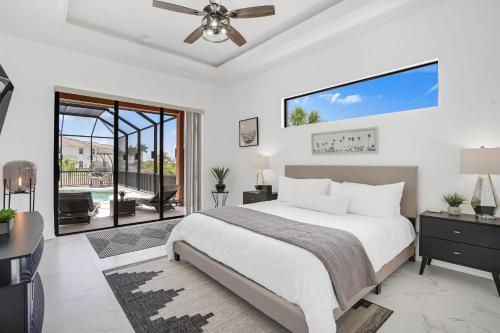 a bedroom with a bed and a ceiling fan at Luxury Villa in Punta Gorda Isles in Punta Gorda
