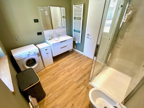 a bathroom with a sink and a washing machine at Villa Dada in Predazzo