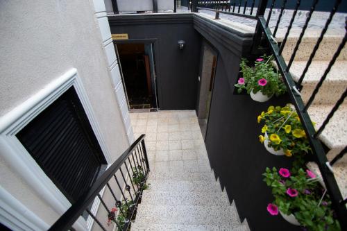 a balcony with flowers on the side of a building at Boutique Hotel Kooperativa in Pogradec