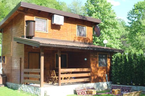 a log cabin with a porch and a porch at Paradise on the Vrbas River in Jajce