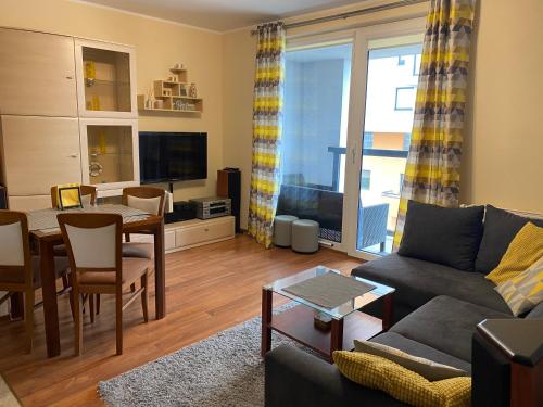 a living room with a couch and a table at Ann Apartament Horyzont in Gdańsk