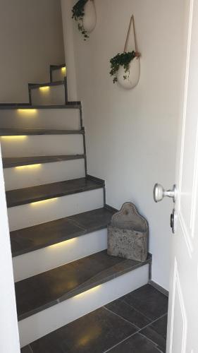 a hallway with stairs with a suitcase on the floor at Aghèl Luxury Room in Recanati