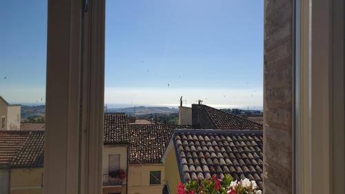 a view of roofs from a window of a building at Aghèl Luxury Room in Recanati