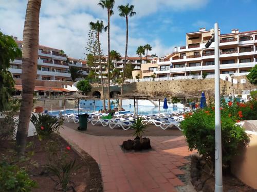 a resort with a swimming pool and a hotel at Apartment South Tenerife in San Miguel de Abona