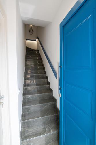 a blue door leading up to a staircase at MARE e Terra Holiday fronte mare in San Vito lo Capo