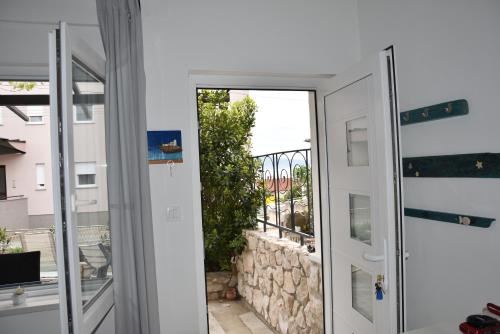 a door leading into a room with a balcony at Apartman Vitamare 160 m from the beach in Novi Vinodolski