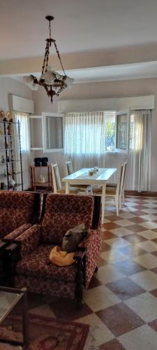 a living room with a couch and a table at Casona LA FLORIDA con parque y pileta, a una cuadra del río in Rosario