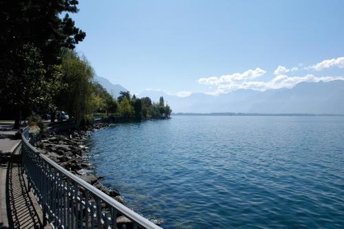 a view of a lake with mountains in the background at Montreux Youth Hostel in Montreux