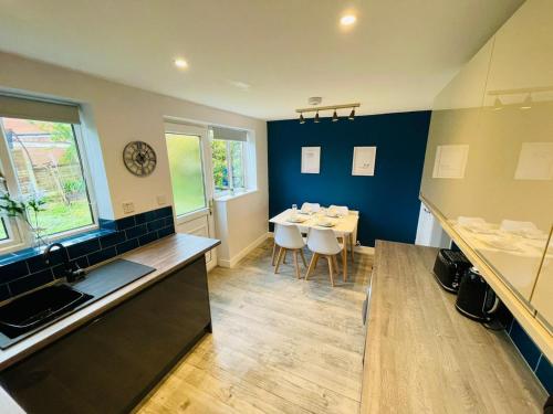 a kitchen and dining room with a table and chairs at Newly refurbished 3 bedroom house in Heysham