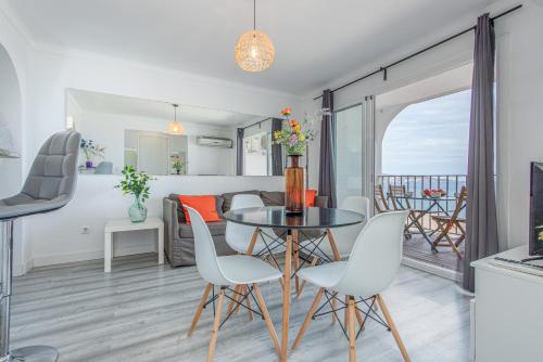 a dining room and living room with a table and chairs at BLUE HOLIDAYS RELAX & VIEWS Sylvia12 in Empuriabrava