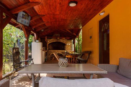 a patio with a table and a fireplace at Villa M in Vinci
