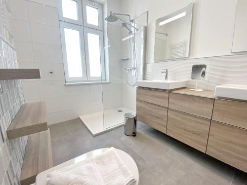 a bathroom with a sink and a toilet and a mirror at Villa Jenny Sassnitz Villa Jenny - Appartement 3 in Sassnitz