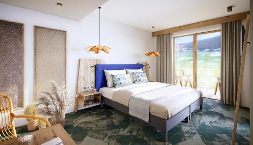 a bedroom with a bed with a blue headboard at Auberge d'Aillon et d'Ailleurs in Aillon-le-Jeune