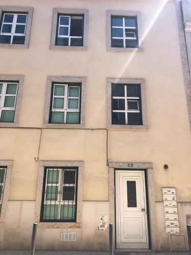a building with a white door and windows at LX Lisboa Cozy studio in Lisbon