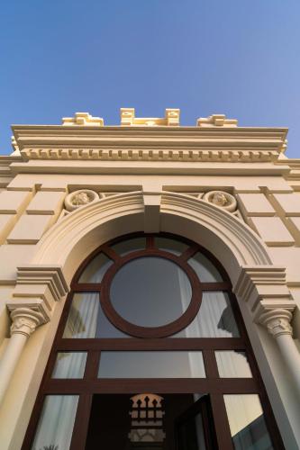 a building with a large window on top of it at CISNES PALACE in Sanlúcar de Barrameda