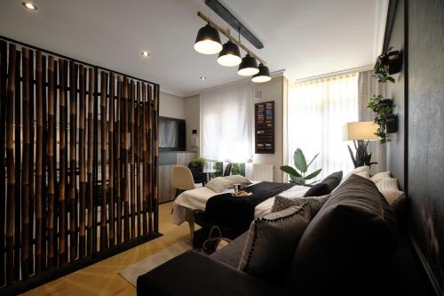 a living room with a couch and a table at El Balconcillo - Apartamento boutique en pleno centro - Grupo Querbes in Gijón