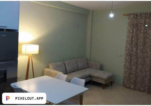 a living room with a couch and a table at Comfort Apartment in Tirana