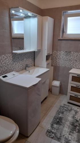 a small kitchen with a sink and a toilet at MERICA Kneže in Korčula