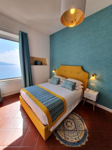 a bedroom with a bed and a large window at Bella Vista House-Sorrento coast - free parking-solarium in Vico Equense