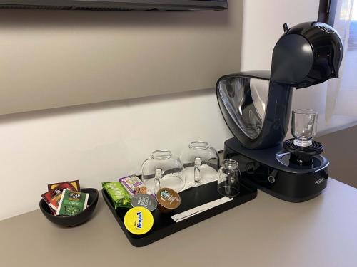 a coffee maker on a counter with a coffee machine at L'Ulivo Comfort Rooms in Terrasini