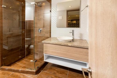 a bathroom with a sink and a shower at CentralX 18 in Bogotá