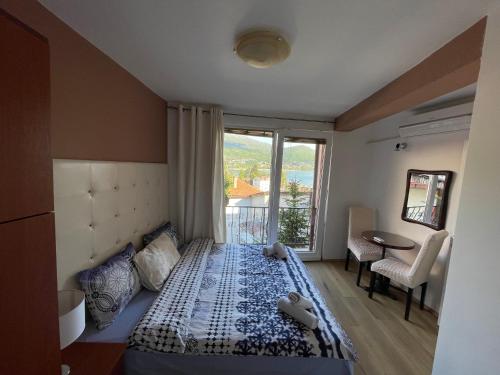 a bedroom with a bed and a window and a table at Villa Stefanija in Ohrid