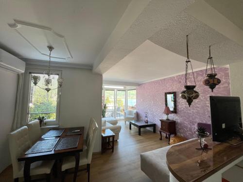 a living room with a table and a dining room at Villa Stefanija in Ohrid