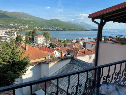 a balcony with a view of a city and water at Villa Stefanija in Ohrid