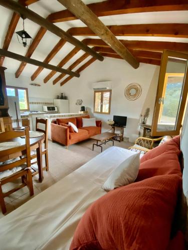 une chambre avec un grand lit et un salon dans l'établissement Bergerie FIORA, Domaine de l Ogliastru, à Olmeto