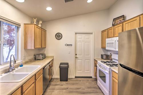 a kitchen with a sink and a stove at Kid-Friendly Kingman Home Near Parks and Dining in Kingman