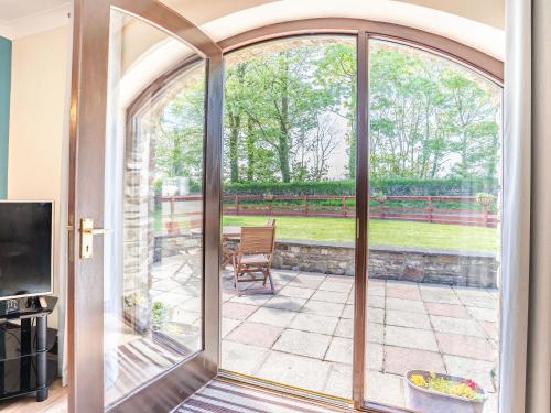 a sliding glass door with a view of a patio at Highbury in Spittal