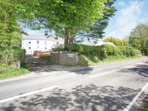 an empty road with a tree on the side of the road at Highbury in Spittal