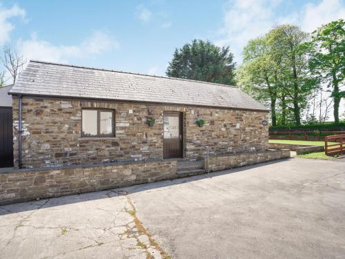 a stone building with a door in a parking lot at Highbury in Spittal