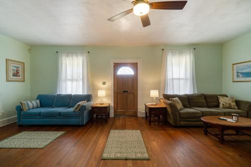 a living room with two couches and a ceiling fan at Captains Quarters by the Bay cottage in Norfolk