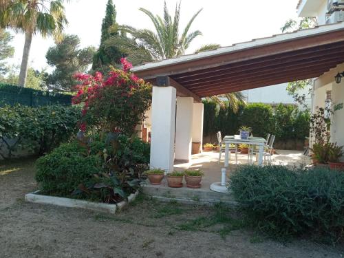a patio with a table and some plants at Cap de Mar in Alcudia