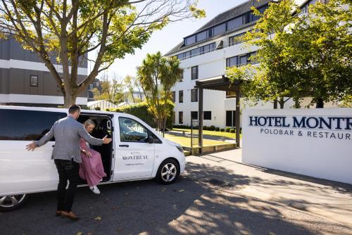 a man and a woman getting into a white van at Hotel Montreal in Christchurch