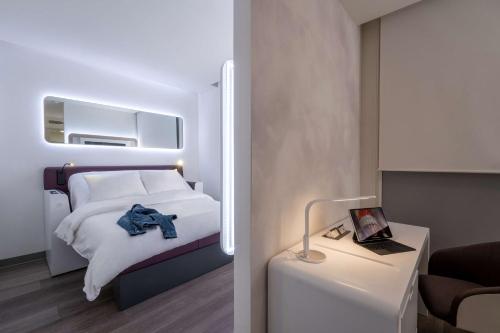 a hotel room with a bed and a desk at YOTELAIR Istanbul Airport, Duty free - International Transit area in Istanbul