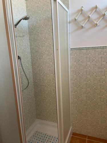 a shower with a glass door in a bathroom at Incantevole appartamento Sole, in centro in Stintino