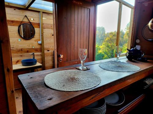 a wooden table with two glasses and plates on it at WoodHouse Near River - Near Ocean - Near Porto in Porto