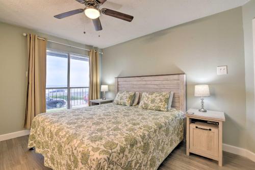 a bedroom with a bed with a ceiling fan and a window at Gulf Views and Resort Perks Walkable Galveston Gem in Galveston
