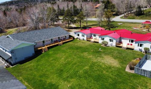 an aerial view of a house with red roofs at Trailsman Lodge in Baddeck