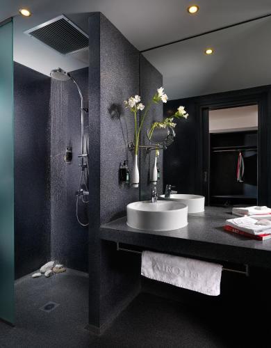 a bathroom with a sink and a shower at Airotel Patras Smart Hotel in Patra