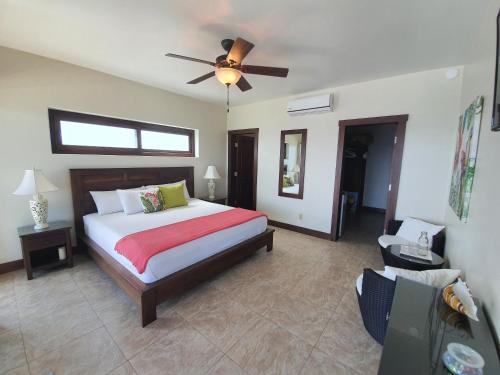 a bedroom with a bed and a ceiling fan at Fishers Landing Boutique Hotel in Roatan