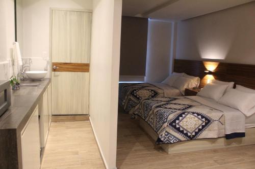 Postel nebo postele na pokoji v ubytování BERTHEL SUITES